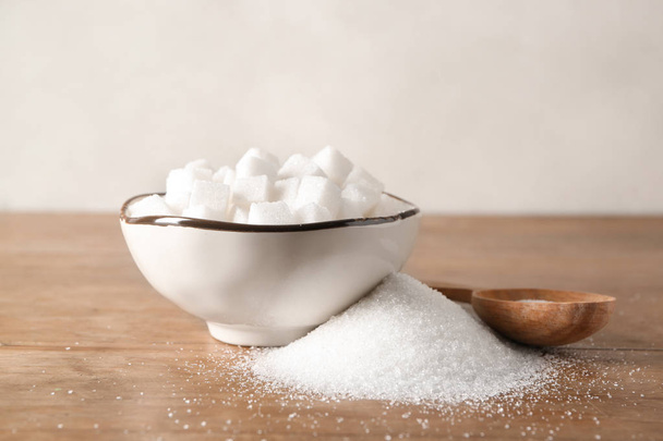 Bowl with sugar cubes on wooden table - Photo, Image