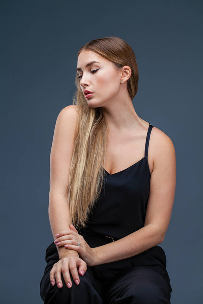 Happy Beautiful blonde woman in black dress, studio isolated on gray background - Foto, immagini