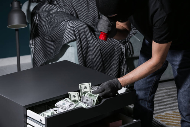 Male thief finding money in flat - Foto, Bild
