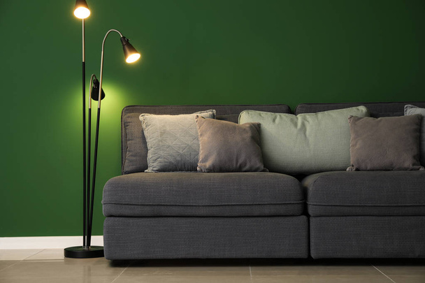 Stylish interior of room with comfortable big sofa near color wall - Photo, Image
