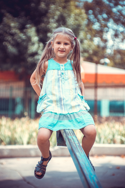 Cute little girl on the playground. - 写真・画像