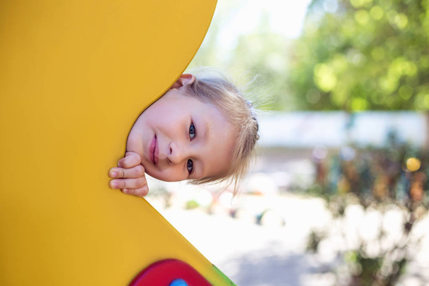 Little cute girl on the playground in the summer. - Φωτογραφία, εικόνα