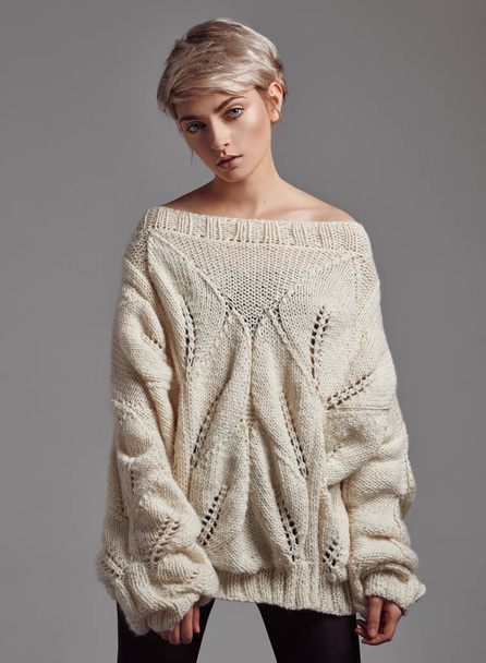 Fashion photo of young woman with blond short hair wear wool sweater - Photo, image