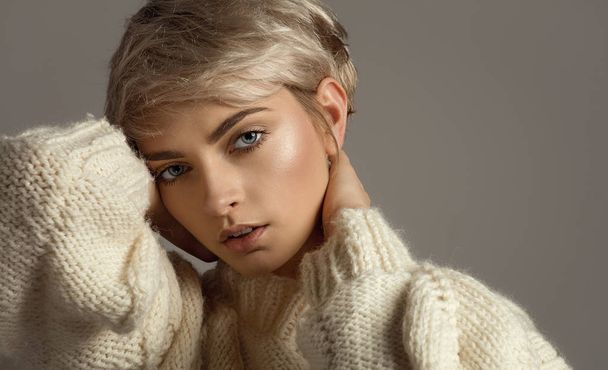 Portrait of natural beauty with blond short hair looking at camera isolated on gray background - Fotó, kép