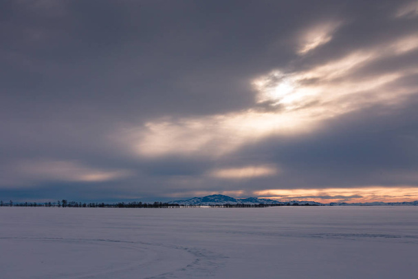 the sun's rays make their way through the dark clouds, Altai, Russia - Fotó, kép