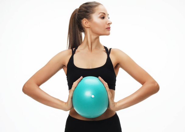 Athletic woman doing exercise with medicine ball. - Foto, afbeelding