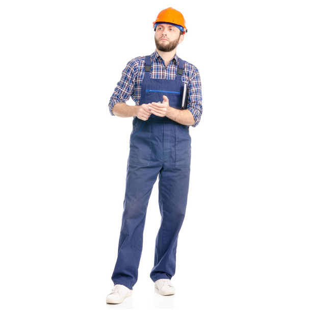 Young man builder industry worker hardhat with a notebook and pen in hand on white background isolation - Foto, immagini