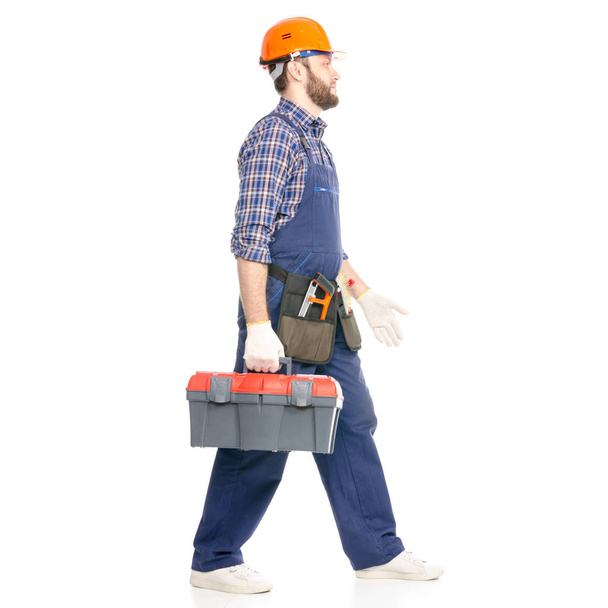 Young man builder with toolbox industry worker hardhat coming going - 写真・画像
