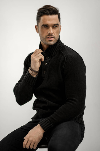Handsome man in black wool turtleneck jumper isolated on white background - Foto, Imagen