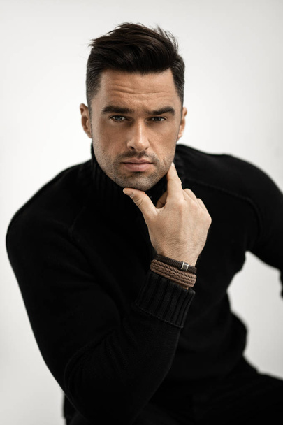 Portrait of handsome man in black turtleneck jumper isolated on white background - Zdjęcie, obraz