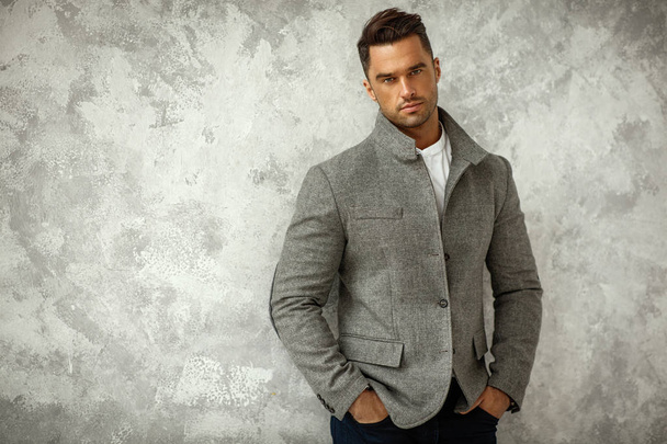 Portrait of handsome man in gray stylish jacket with copy space for your text - Фото, зображення