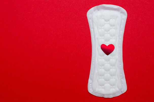 menstruation concept. an image of a menstrual pad on red background - Foto, Imagem