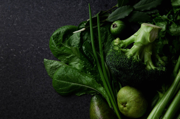 Fresh green vegetables with greens and fruits on dark concrete background, Monochromatic idea - Foto, Bild