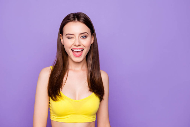 Portrait of lovely cute sweet gorgeous nice lady with her beaming toothy smile she look at camera stand isolated on vivid purple background yellow outfit - Фото, изображение