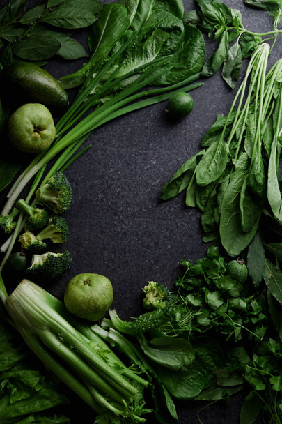 Fresh green vegetables with greens and fruits on dark concrete background, Monochromatic idea - Фото, зображення