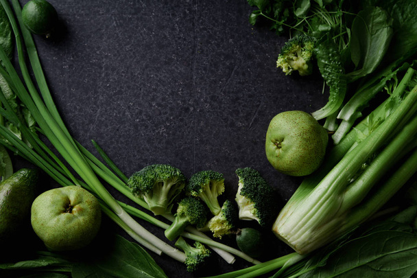 Fresh green vegetables with greens and fruits on dark concrete background, Monochromatic idea - Fotó, kép