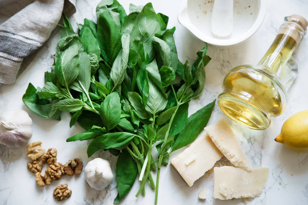 composition of basil pesto ingredients on marble background. Top view  - 写真・画像