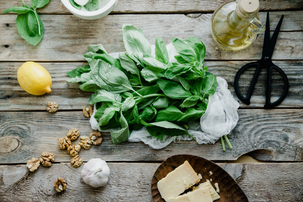 Basil pesto ingredients on wooden background, top view  - Photo, image
