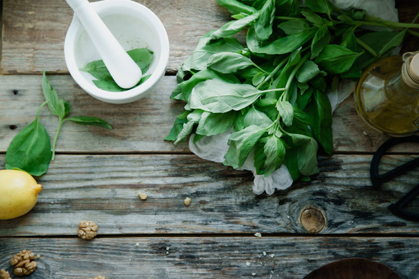 Basil pesto ingredients on wooden background, top view  - Foto, immagini