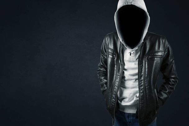 faceless hacker standing on the dark background - Photo, Image