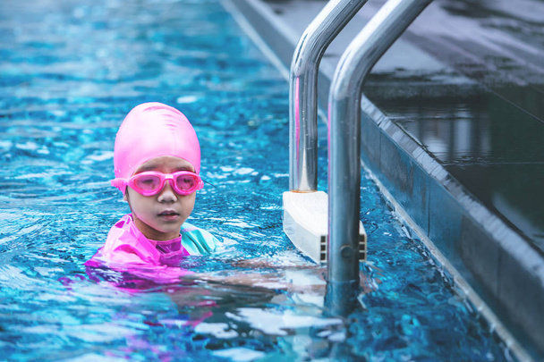 Little asian girl is swimming with glasses - Photo, Image