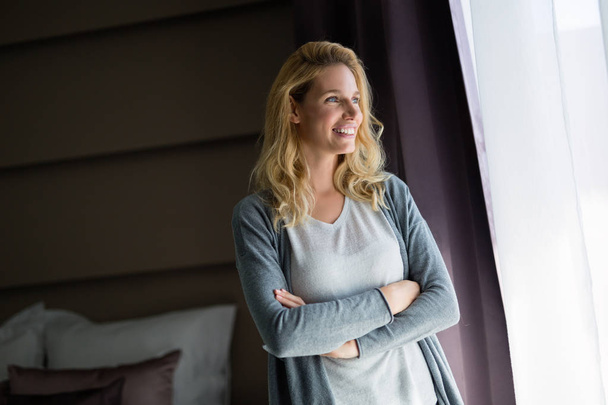 Portrait of attractive blonde woman in hotel room - Photo, Image