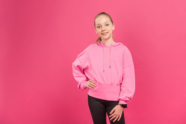 athletic preteen kid posing in sportswear, isolated on pink - Photo, Image
