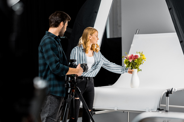 professional young photographers shooting beautiful flowers in photo studio - Zdjęcie, obraz