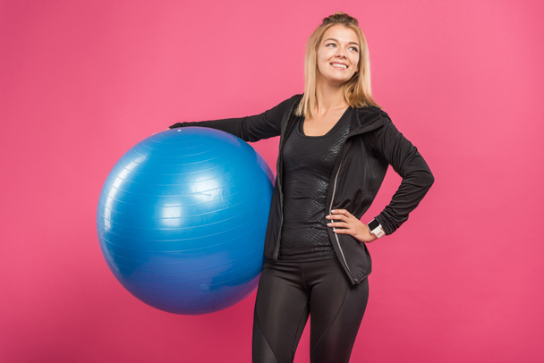 beautiful sportswoman holding fitness balls, isolated on pink - Foto, imagen