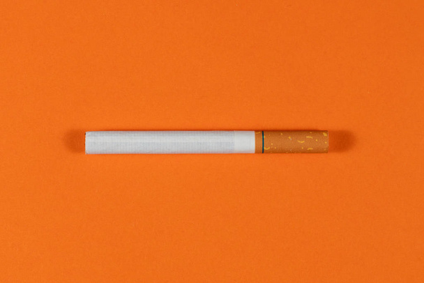 Tobacco Cigarette close up with orange background - Photo, Image