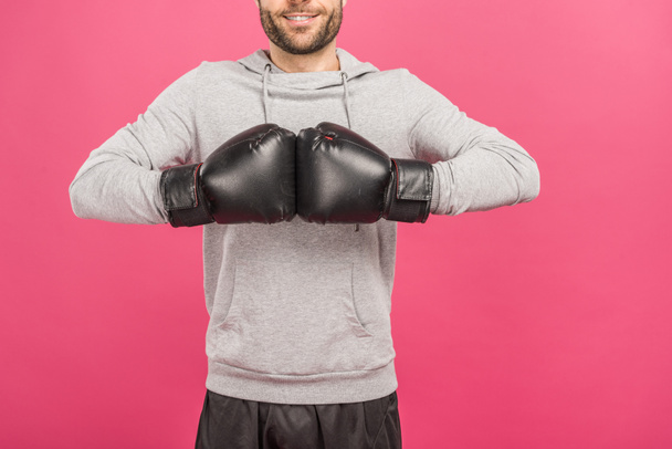 cropped view of sportsman in box gloves, isolated on pink - 写真・画像