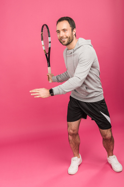 handsome male tennis player with racket, isolated on pink - Photo, Image