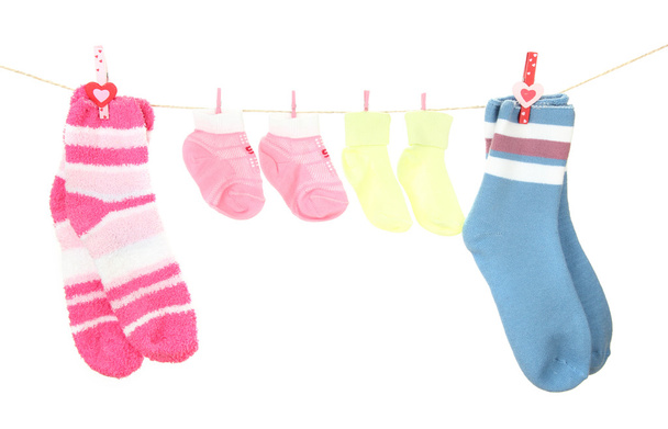 Colorful socks hanging on clothesline, isolated on white - Фото, изображение