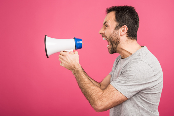 aggressive man shouting with megaphone, isolated on pink - Fotografie, Obrázek