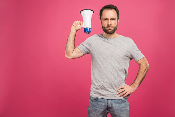 angry man holding megaphone, isolated on pink  - Photo, Image
