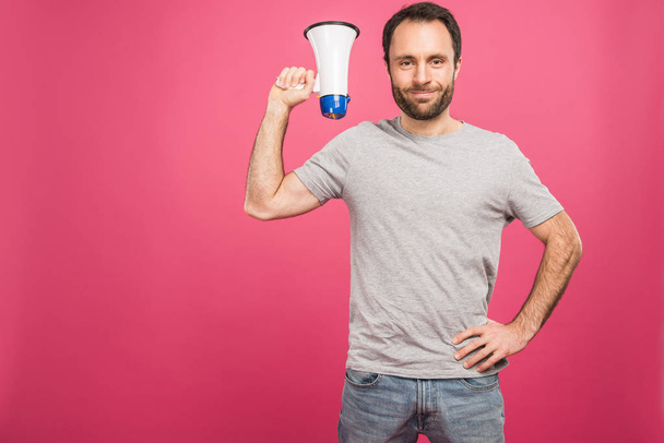 smiling man holding megaphone, isolated on pink  - Foto, immagini