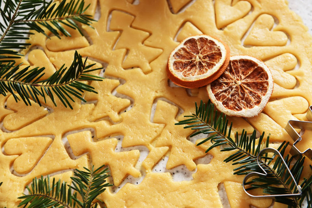 Cooking Christmas cookies for Christmas. The dough is cut figures.Flat lay with bright christmas decoration. New year celebration and christmas concept - Foto, imagen