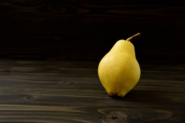 Yellow ripe fresh pear on old wooden board - Foto, Imagen