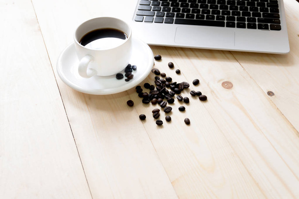 laptop, cup of fresh coffee and coffee beans - Фото, зображення