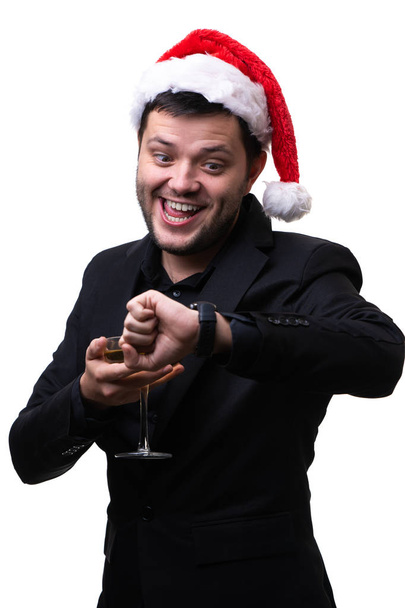 Photo of happy man in santa hat with champagne glass and clock on hand - Zdjęcie, obraz