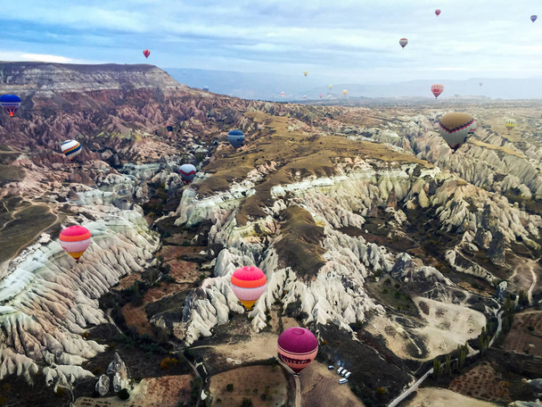 Hot air balloons flying over Cappadocia, a famous travel spot in Turkey - Valokuva, kuva