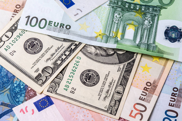 Euro banknotes and American Dollars bills of various denominations close-up. - Photo, Image