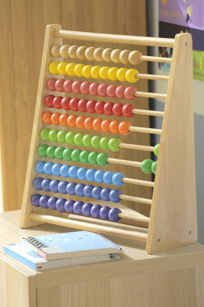 a colorful wooden abacus is a classic education toy usually met in kindergarten school - Photo, Image