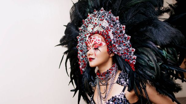 Portrait of a young beautiful woman in a creative look. The style of carnival and dancing. - Фото, зображення