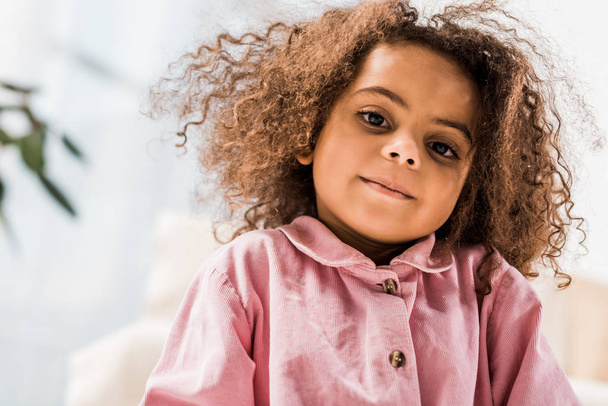 beautiful curly african american child looking at camera and smiling - Photo, Image