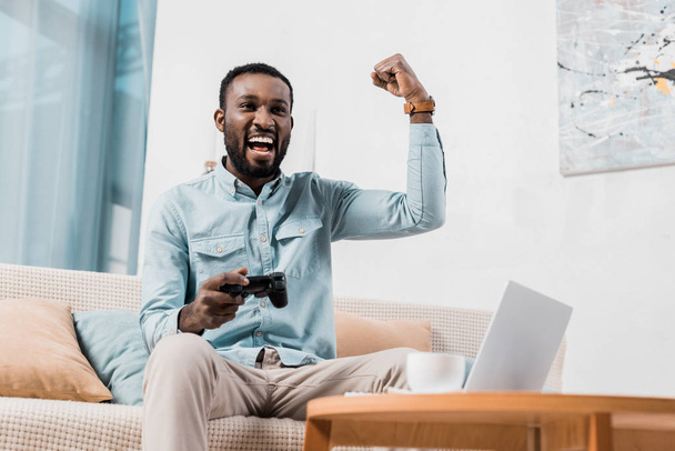 Afrika kökenli Amerikalı adam video oyunu oynarken sevindirici  - Fotoğraf, Görsel