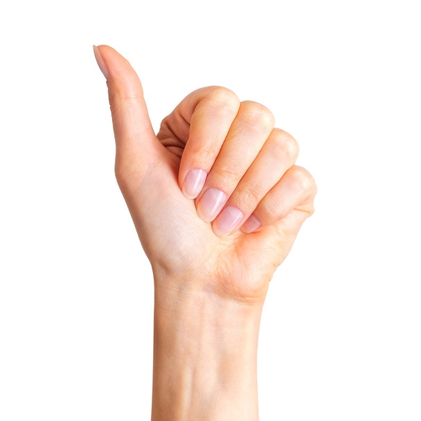 Woman holding hand in gesture of like sign, giving thumb up - Φωτογραφία, εικόνα