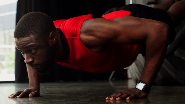 african american sportsman doing push ups at gym in slow motion - 映像、動画
