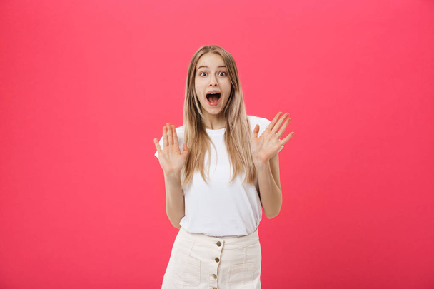 Surprised teenage student girl show shocking expression with something. Isolated on Bright Pink Background. Copy space - Photo, image