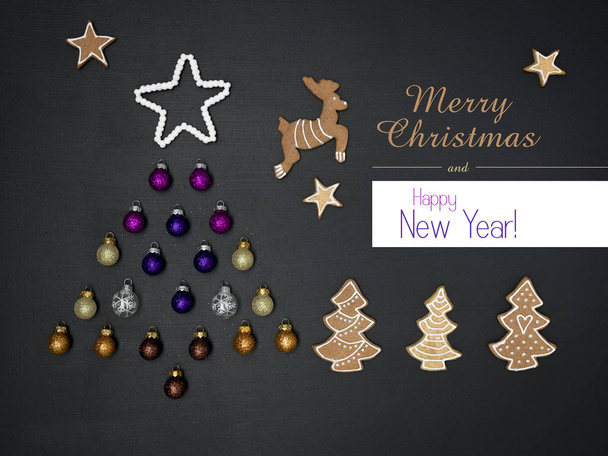greeting lettering and tree shaped out of Christmas decorative items on black chalkboard background, New Year concept  - Photo, Image